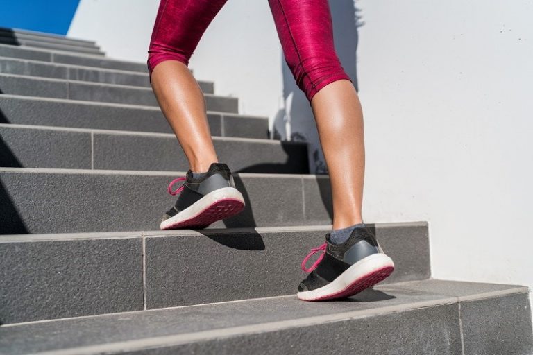 Legs of a woman walking up the stairs to burn more calories