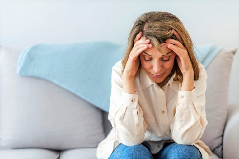 stressed out woman sitting on couch
