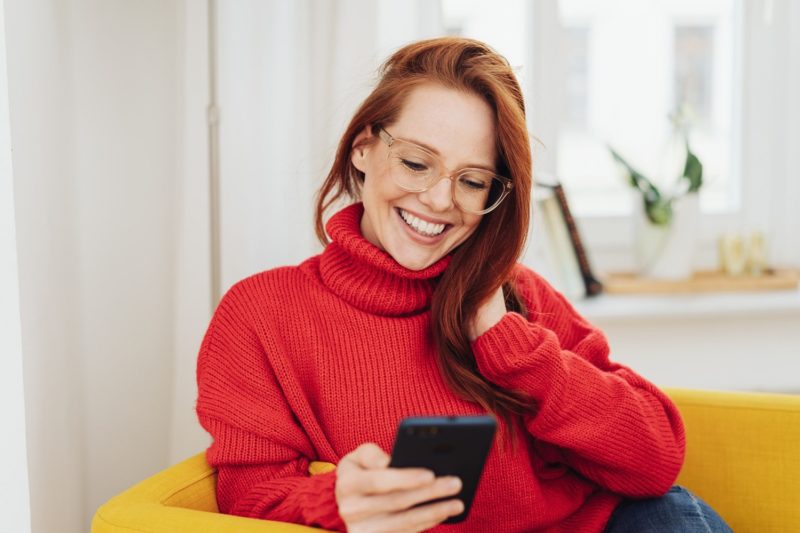 woman entering February giveaway on smart phone